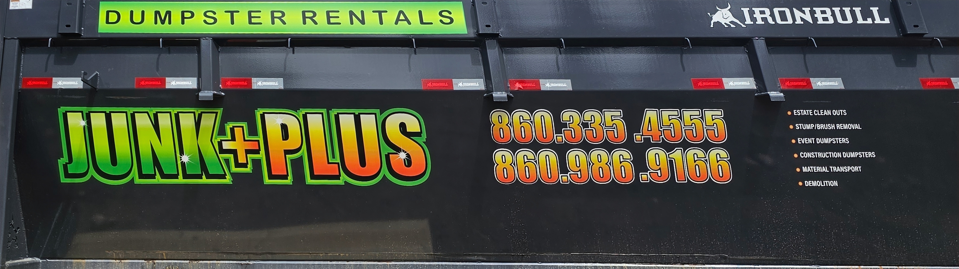 Close-up of Junk Plus dumpster logo and phone numbers.